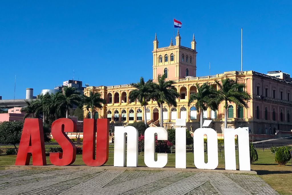 Asuncion sign and Lopez Presidential Palace, Paraguay
